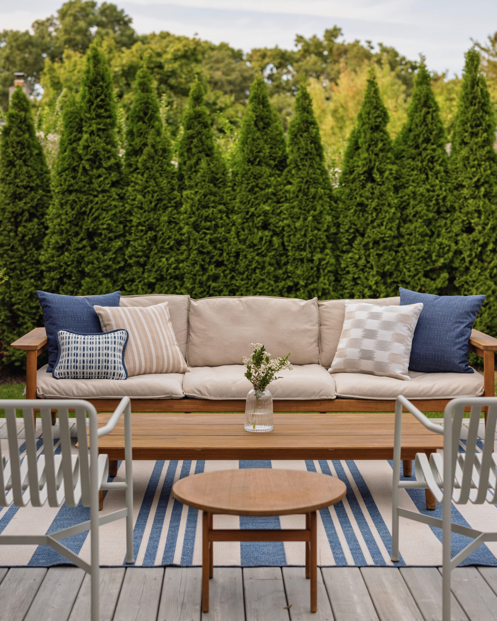 Outdoor sofa with new custom pillows in beige stripe