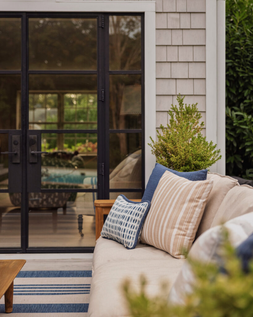 Outdoor sofa with new custom pillows in beige stripe