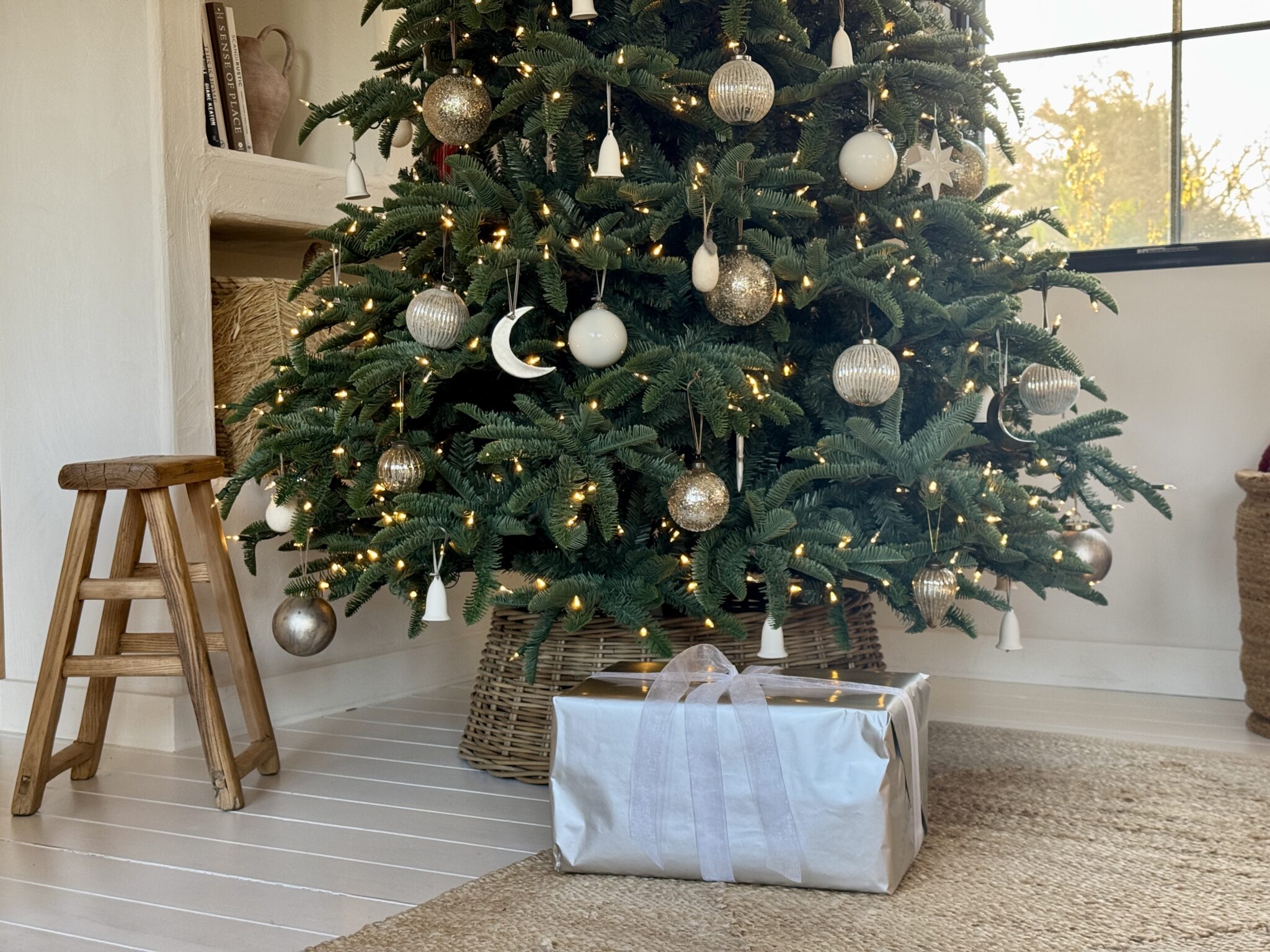 Christmas tree with gold lights, moon, stars and silver wrap